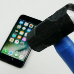 Sludge hammer with blue handle coming down on iPhone