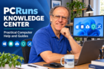 John Zettel at the PCRuns Knowledge Center workspace with a PCRuns-branded coffee mug