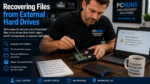 Computer technician recovering files from a damaged external hard drive connected to a Windows laptop.
